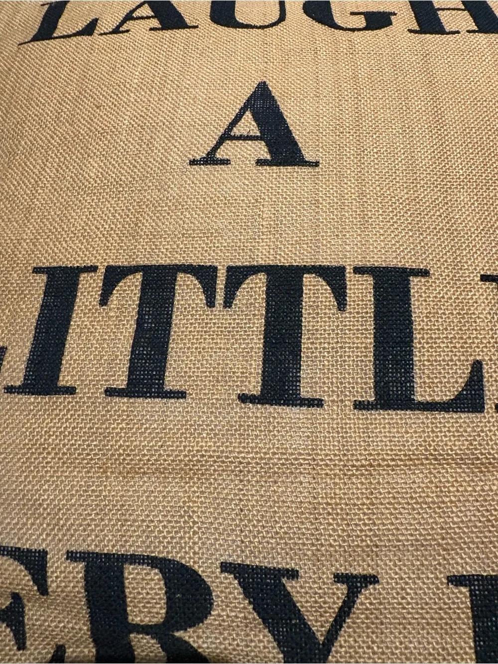 Laugh A Little Every Day Burlap Accent Pillow - Tan with Black Letters.